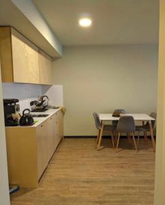 a kitchen with a sink and a table with chairs at Koktha-Mitarbi Resort Block 1 Appt 215 in Bakuriani