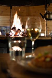 a table with a glass of wine and a plate of food at Nova Galaxy Village in Rovaniemi +105 photos