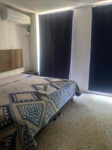 a bedroom with a bed with a table on it at Hotel San Francisco in Villahermosa