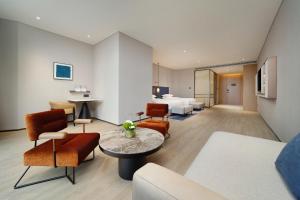 a living room with a couch and a table at Novotel Chengdu Lige in Chengdu +116 photos