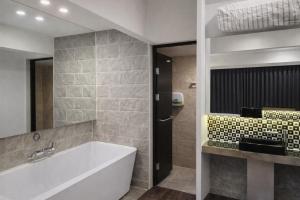a bathroom with a tub and a sink at Haeundae HaeRium Hotel in Busan +79 photos
