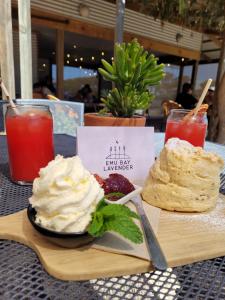 a table with a plate of food and drinks at The Peppercorn Shack in Kingscote