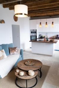 a living room with a couch and a table at Love Room Evasion Jacuzzi Sauna Hamamm in Saint-Cyr-sur-Loire