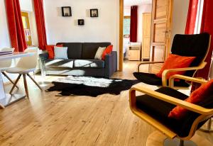 a living room with a couch and chairs at Haus Thomas in Werfenweng