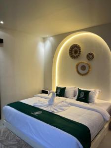 a bedroom with a large bed with an arch above it at Sampai Villa Kama in Ngaglik