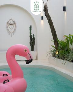 a pink flamingo float in a swimming pool at Sampai Villa Kama in Ngaglik