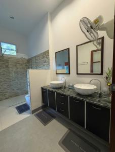 a bathroom with two sinks and a shower at Sunset bay view villa krabi in Ban Khao Thong +5 photos