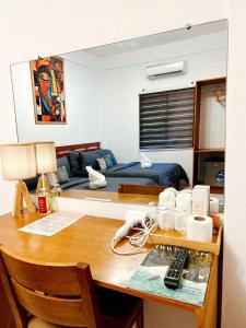 a room with a desk with a room with a couch at Who's Gloria in El Nido