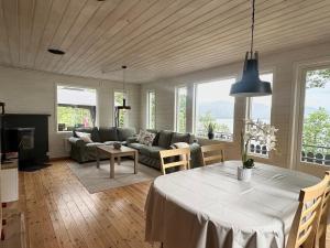 a living room with a table and a couch at Look at this view! 3 BR house overlooking Hardangerfjorden in Kvam