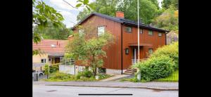 a large red house on the side of a street at Apartment close to central city in Gothenburg