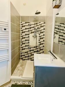 a bathroom with a sink and a shower at L entre deux charentes in Montils +3 photos
