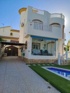 a house with a swimming pool in front of it at Luxury Private Pool Villa Campoverde in Pinar de Campoverde