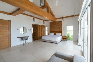 a bedroom with a bed and a couch at Nalas Villa in Ketewel +79 photos