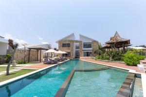 a swimming pool in front of a villa at Nalas Villa in Ketewel