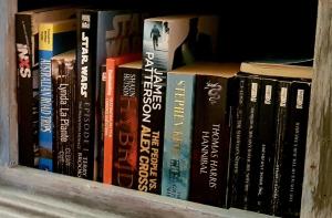 a bunch of books sitting on a shelf at Number 4 Smugglers Inn in Victor Harbor