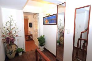 a hallway with potted plants and a mirror at Dan Chi Hotel in Da Lat