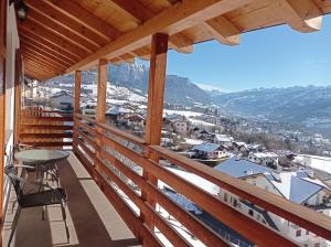 a balcony with a table and a view of a city at Varesco Appartamenti in Carano