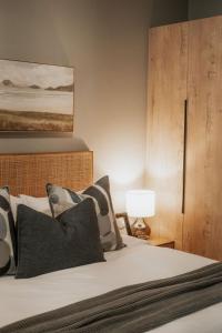 a bedroom with a bed with a wooden headboard at IBella's at The Urban in Pretoria