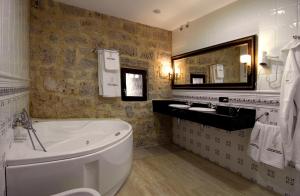 Un baño con bañera, lavabo y espejo. en Señorio de Olmillos, en Olmillos de Sasamón 37 fotos más