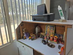 a shelf with figurines on it next to a window at the varun residency in Greater Noida