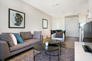 a living room with a couch and a table at Soda Apartments by CLLIX in Brisbane
