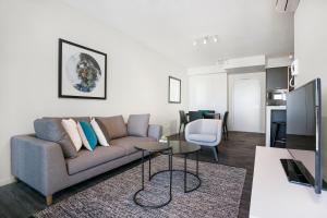 a living room filled with furniture and a tv at Soda Apartments in Brisbane