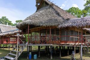 a large hut with a thatched roof and a staircase at CAMUNGO jungle Lodge in indigenous community ALL INCLUSIVE in Puerto Franco +100 photos