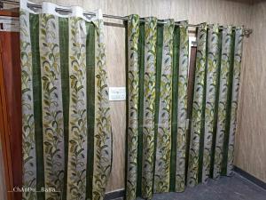 a row of gold and green decorative dividers on a wall at Hotel Amit Kedar Dham in Sirsi