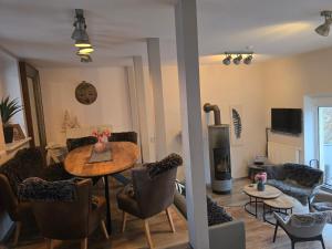 a living room with a table and chairs and a fireplace at Palais Picard Ostflügel in Thale