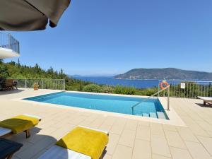 a swimming pool with a view of the water at Villa Vassilis Fiscardo Kefalonia in Katsaráta