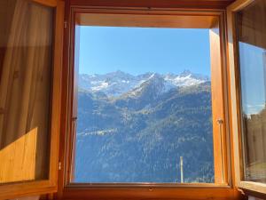 a window with a view of a mountain at Chalet del Sole in Quinto