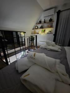 a bedroom with two white towels on a bed at Holiday house Aria Vučedol in Vukovar