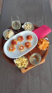 a table with a plate of food and bowls of food at TCEM camera in attico 6 no ascensore in Piombino +9 photos