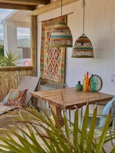 a dining room with a wooden table and a window at Casa Bambú Boutique Studios Andalusië with pool and Mountain Views in Vélez-Málaga