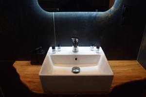 a white sink in a bathroom with a mirror at Blue Horizon in Sevastí