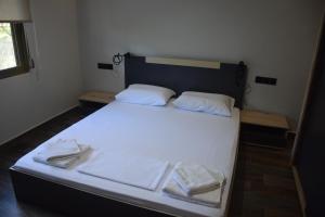 a bedroom with a white bed with towels on it at Blue Horizon in Sevastí +26 photos