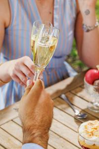 a person holding a glass of wine on a table at The Fleece in Witney