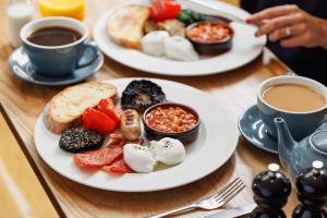 two plates of food on a table with cups of coffee at The Fleece in Witney +68 photos
