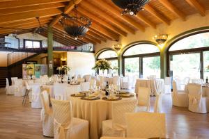 a banquet hall with white tables and chairs at Agriturismo Greppi in Crescentino +44 photos