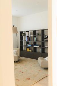 a living room with a couch and a book shelf at Albergo Sappia in Arma di Taggia