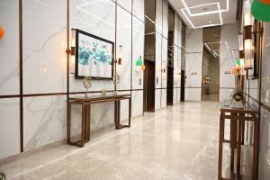 a hallway of a building with a painting on the wall at Let's Loft - A Premium Luxury Style Duplex Living in Gurgaon