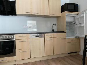a kitchen with wooden cabinets and a black counter top at Haus Caré in Weissensee