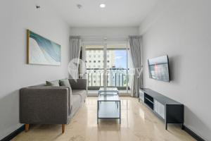 a living room with a couch and a table at Tanea by Kozystay - Braga in Bandung