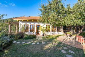 a home with a garden and a house at אזמרה בית אירוח מיוחד עם נוף מדהים ובריכה מחוממת בישוב אמירים in Amirim