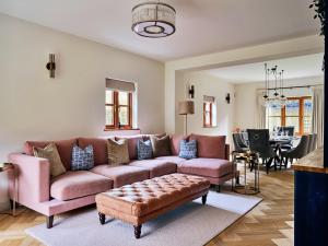 a living room with a couch and a table at Finest Retreats - Sea Gables in Exmouth