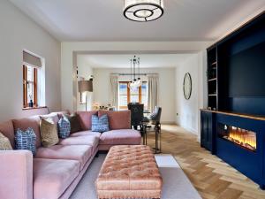 a living room with a couch and a fireplace at Finest Retreats - Sea Gables in Exmouth