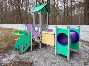 a playground with three play equipment in a park at Hotel Sjesta in Mikołów