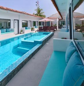 a swimming pool with blue water in a resort at LVIS Pool Villa in Dharavandhoo