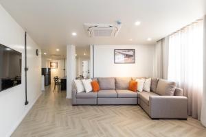 a living room with a couch and a table at Holmes Pranakorn in Bangkok