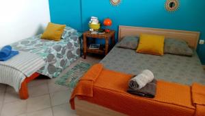 a bedroom with two beds with towels on them at Gite Oiseau du Paradis in Le Marin +5 photos